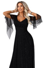 655-1 Długa połyskująca w świetle suknia z dekoltem i transparentnym rękawkiem - czarna-12